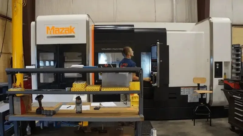 An Astro machinist at a Mazak CNC machining center