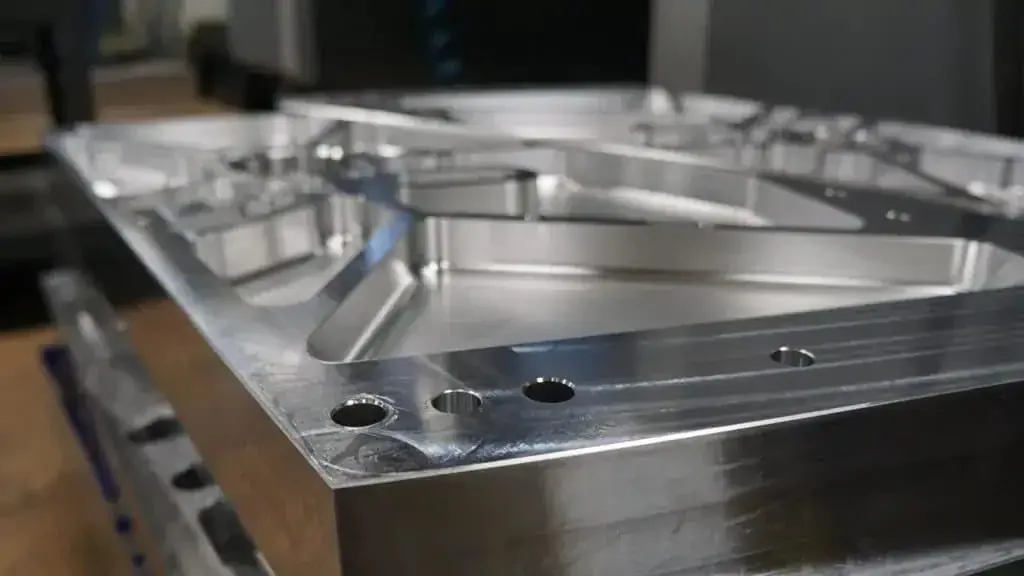 Machined aluminum part with pockets and drilled holes